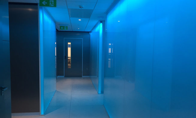 EKM back-lit, glass-walled corridor